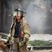 A firefighter walks away from the scene of an explosion at a house on Gattegno Street in Ypsilanti Township on Sunday, July 7. Daniel Brenner I AnnArbor.com